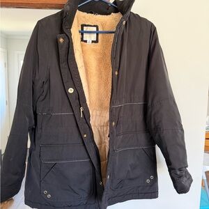 Women’s black coat with fur inside.